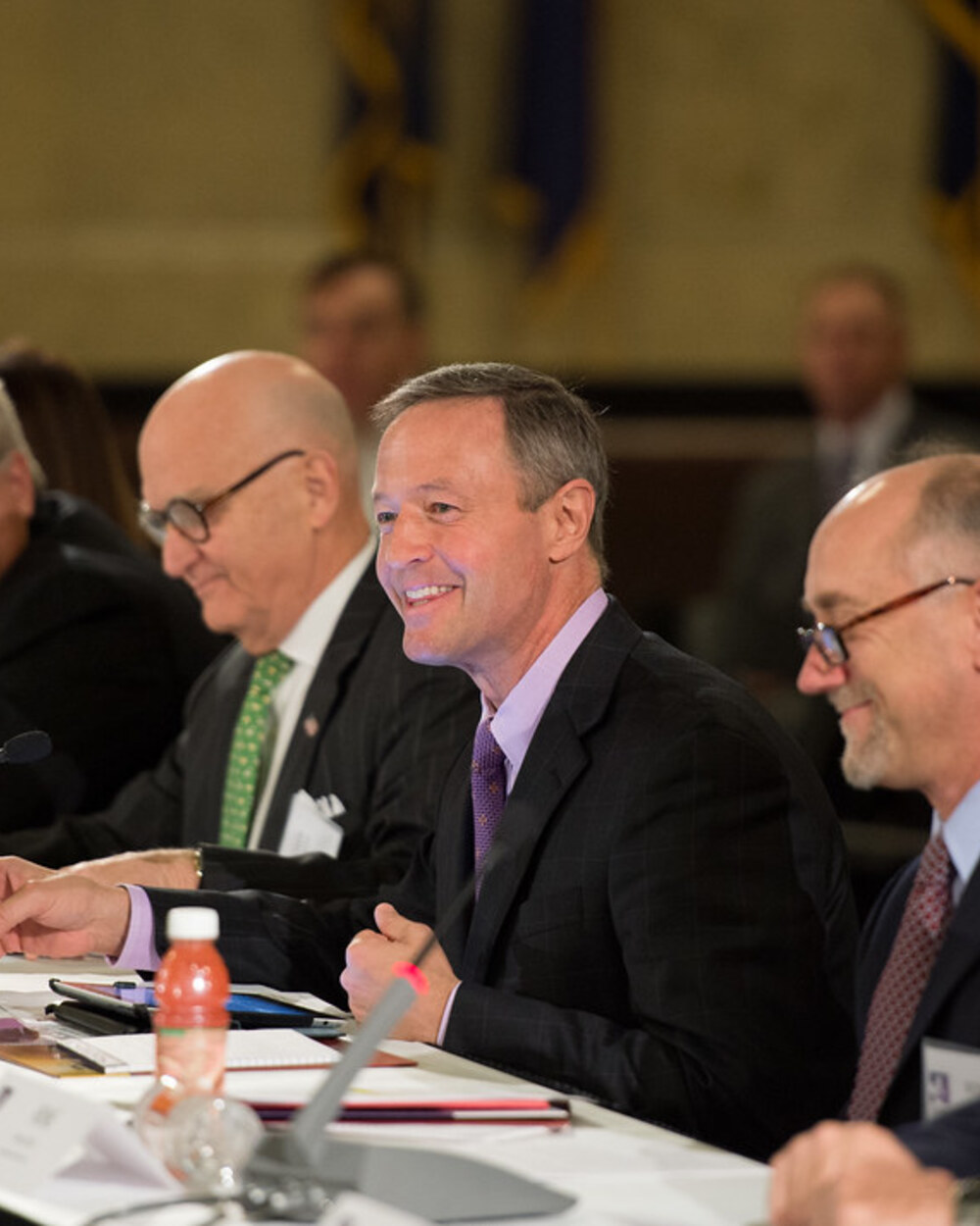 A hiring team gathered around a table discussing role requirements before applicants start coming in