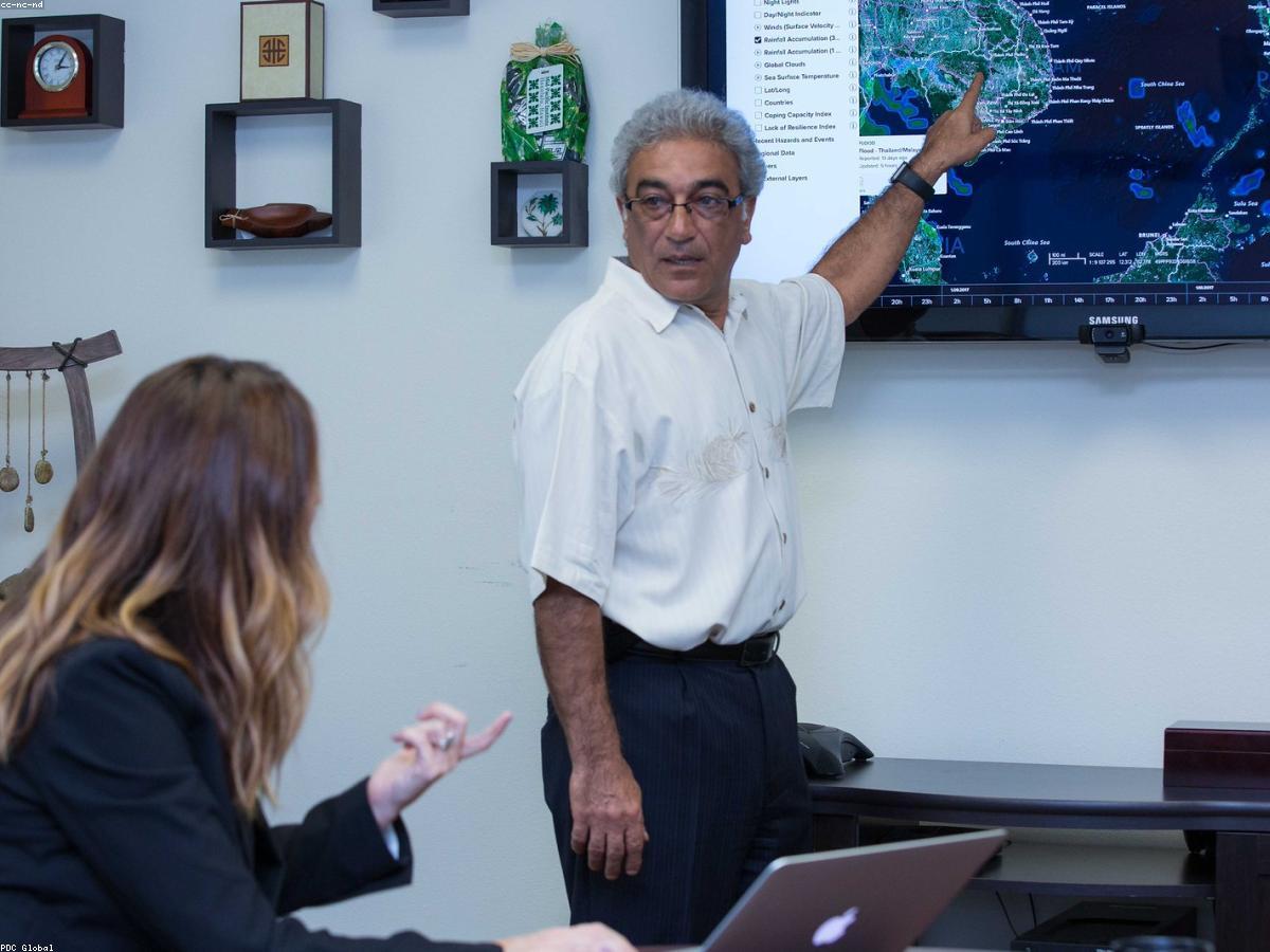 An executive and assistant reviewing the day's agenda together in a meeting room